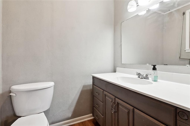 713 Lydia Ct, Marrero, LA 70072 - bathroom featuring toilet, wood finished floors, vanity, a textured wall, and baseboards
