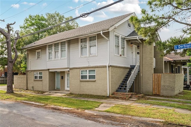 3031 Jena St, New Orleans, LA 70125 - view of front facade featuring fence, stairs, and brick siding