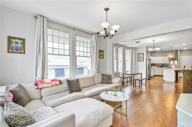 3031 Jena St, New Orleans, LA 70125 - living area featuring light wood finished floors and a chandelier