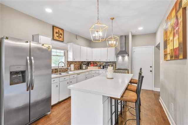 3031 Jena St, New Orleans, LA 70125 - kitchen featuring a sink, wall chimney exhaust hood, stainless steel fridge, light countertops, and white dishwasher