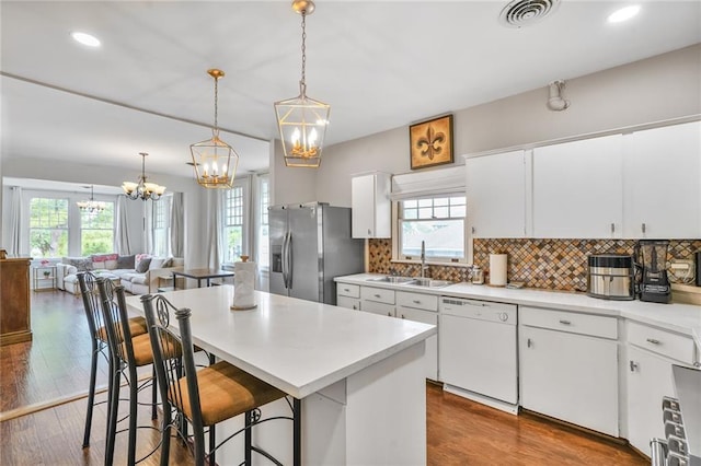 3031 Jena St, New Orleans, LA 70125 - kitchen with a sink, visible vents, stainless steel fridge, white dishwasher, and a notable chandelier