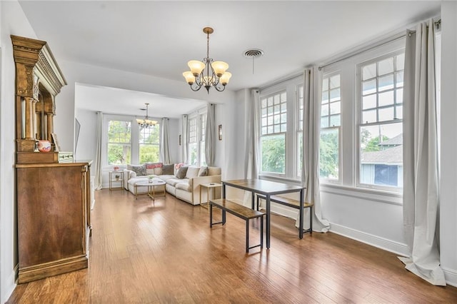 3031 Jena St, New Orleans, LA 70125 - dining area featuring baseboards, a notable chandelier, visible vents, and wood finished floors