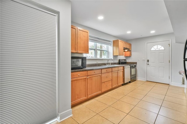3031 Jena St, New Orleans, LA 70125 - kitchen with light tile patterned floors, dark countertops, range with gas stovetop, dishwasher, and black microwave