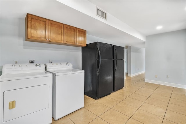 3031 Jena St, New Orleans, LA 70125 - laundry room with cabinet space, visible vents, separate washer and dryer, light tile patterned floors, and baseboards