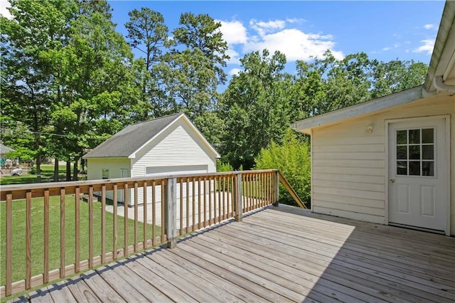 wooden terrace with an outbuilding and a lawn