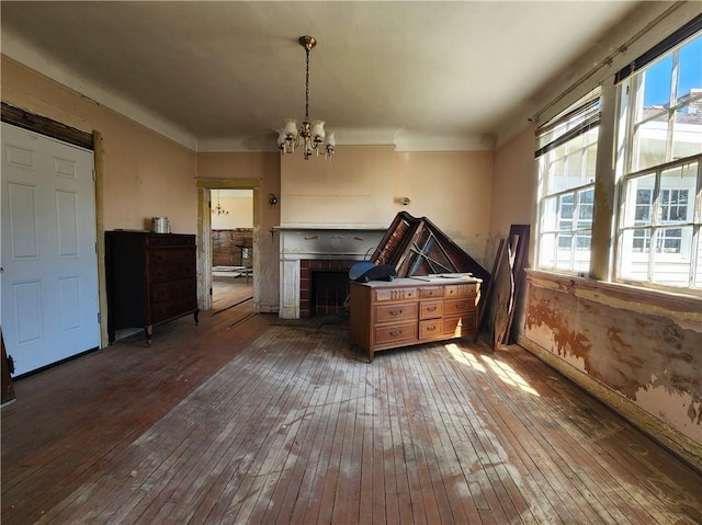 6417 Fleur De Lis Dr, New Orleans, LA 70124 - dining space with wood-type flooring, a chandelier, baseboards, and a fireplace