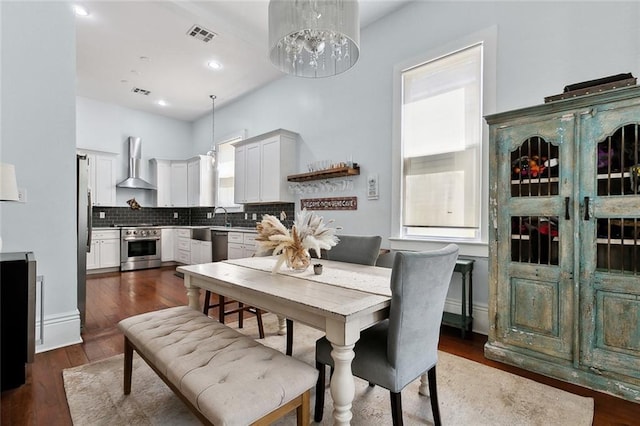 3605 Constance St, New Orleans, LA 70115 - dining area with dark wood-style flooring, a wealth of natural light, and visible vents