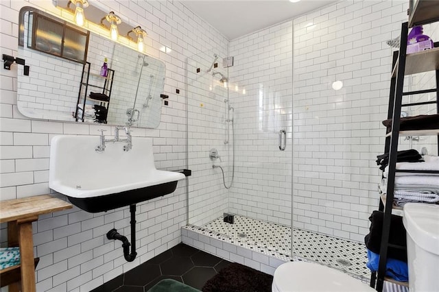 3605 Constance St, New Orleans, LA 70115 - bathroom featuring toilet, tile patterned flooring, tile walls, and a shower stall