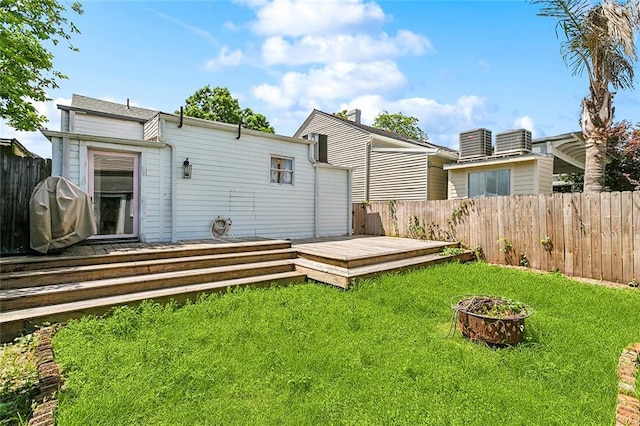3605 Constance St, New Orleans, LA 70115 - rear view of house with a yard, a deck, and a fenced backyard