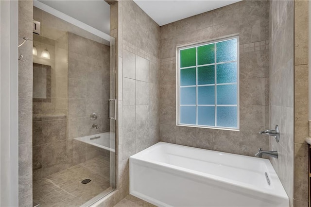 full bathroom featuring a stall shower and a garden tub