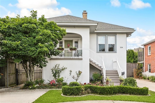504 N Labarre Rd, Metairie, LA 70001 - exterior space featuring a chimney, fence, stairs, stucco siding, and a shingled roof