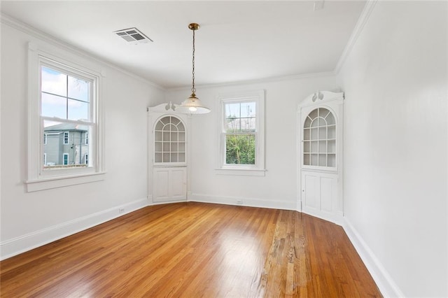 5512 S Tonti St, New Orleans, LA 70125 - unfurnished dining area with crown molding, light wood-style floors, visible vents, and baseboards