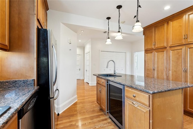 5512 S Tonti St, New Orleans, LA 70125 - kitchen with a sink, appliances with stainless steel finishes, brown cabinets, and beverage cooler
