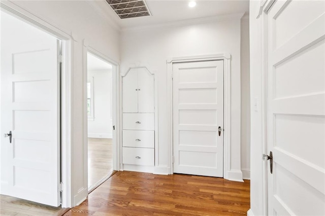 5512 S Tonti St, New Orleans, LA 70125 - hall with visible vents, light wood-style flooring, ornamental molding, and recessed lighting