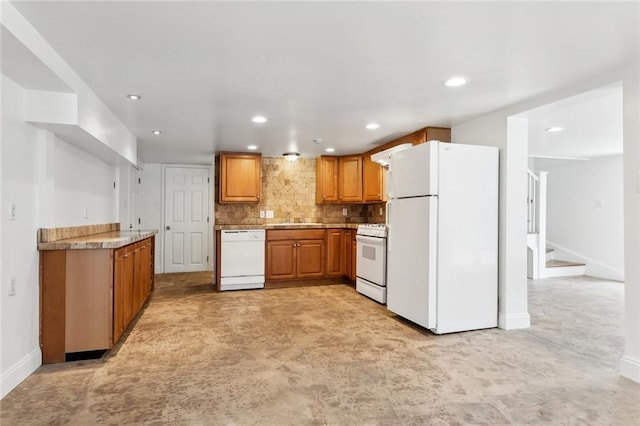 5512 S Tonti St, New Orleans, LA 70125 - kitchen featuring recessed lighting, baseboards, white appliances, a sink, and brown cabinets