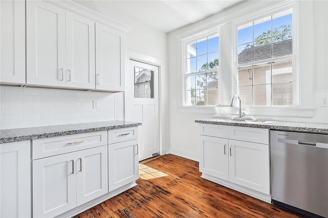 2113 Leonidas St, New Orleans, LA 70118 - kitchen featuring stainless steel dishwasher, dark wood-type flooring, white cabinetry, decorative backsplash, and light stone countertops