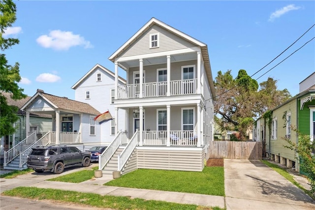 223 S White St, New Orleans, LA 70119 - view of front of property featuring a balcony, stairs, a porch, and fence