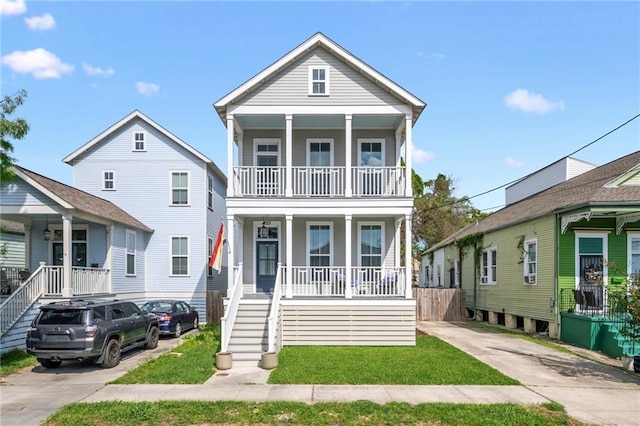 223 S White St, New Orleans, LA 70119 - view of front facade with covered porch, a balcony, and stairway