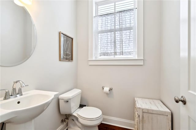 223 S White St, New Orleans, LA 70119 - bathroom with a wealth of natural light, baseboards, toilet, and a sink