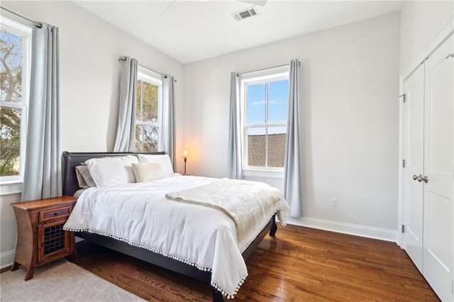 223 S White St, New Orleans, LA 70119 - bedroom with a closet, visible vents, wood finished floors, and baseboards