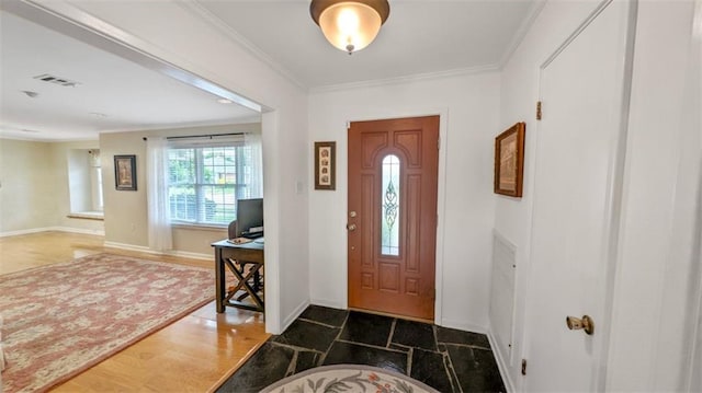 foyer entrance featuring visible vents, baseboards, and ornamental molding
