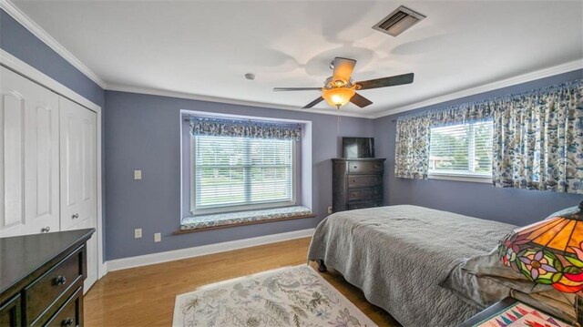 3424 Clifford Dr, Metairie, LA 70002 - bedroom with baseboards, ceiling fan, visible vents, crown molding, and wood finished floors