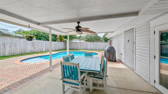 view of swimming pool featuring a patio, a fenced backyard, outdoor dining area, and a ceiling fan