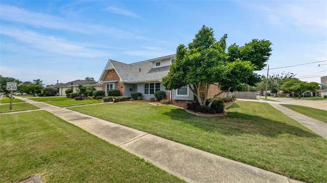 view of front of property featuring a front lawn and brick siding