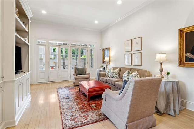 living area featuring ornamental molding, light wood-style floors, and recessed lighting