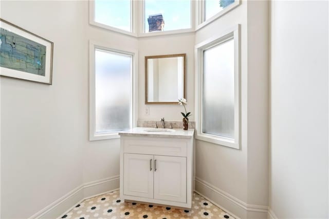bathroom with baseboards and vanity