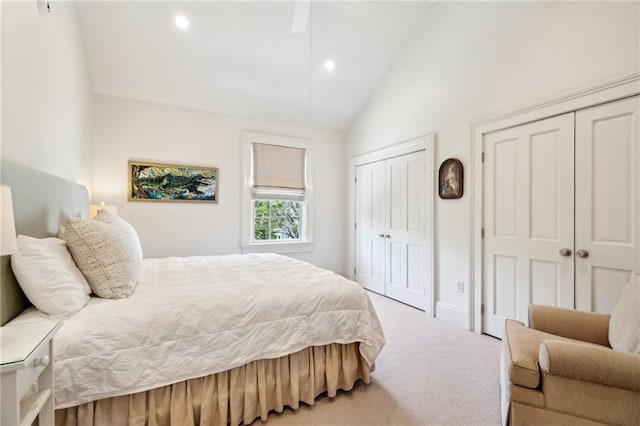 bedroom with two closets, carpet floors, recessed lighting, high vaulted ceiling, and baseboards