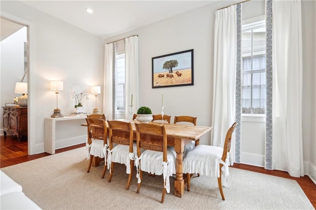 dining area featuring wood finished floors, baseboards, and recessed lighting
