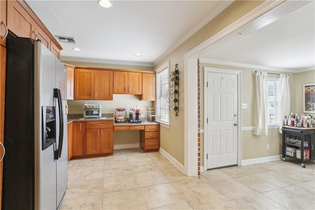 9424 Sharla Dr, River Ridge, LA 70123 - kitchen with stainless steel fridge with ice dispenser, light tile patterned floors, brown cabinetry, and ornamental molding