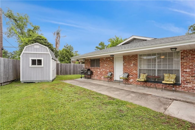 9424 Sharla Dr, River Ridge, LA 70123 - exterior space with a storage unit, an outdoor structure, a fenced backyard, a yard, and brick siding