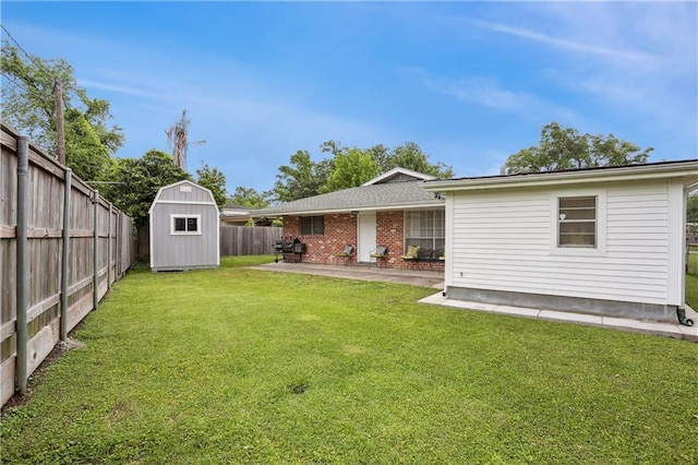 9424 Sharla Dr, River Ridge, LA 70123 - rear view of property with a yard, an outbuilding, a shed, a patio area, and a fenced backyard