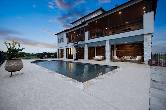 back of house featuring a patio area, outdoor lounge area, and an outdoor pool