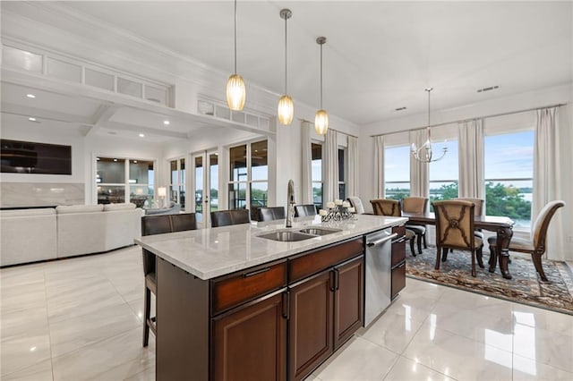kitchen featuring hanging light fixtures, a breakfast bar, a sink, dishwasher, and light stone counters