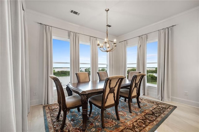 dining room featuring baseboards, crown molding, an inviting chandelier, and visible vents