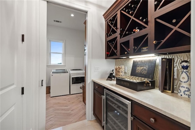 bar with indoor bar, wine cooler, visible vents, recessed lighting, and washer and dryer