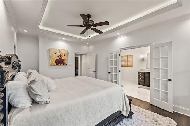 bedroom featuring ornamental molding, french doors, a tray ceiling, and recessed lighting