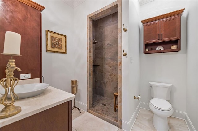 bathroom featuring toilet, walk in shower, vanity, and baseboards