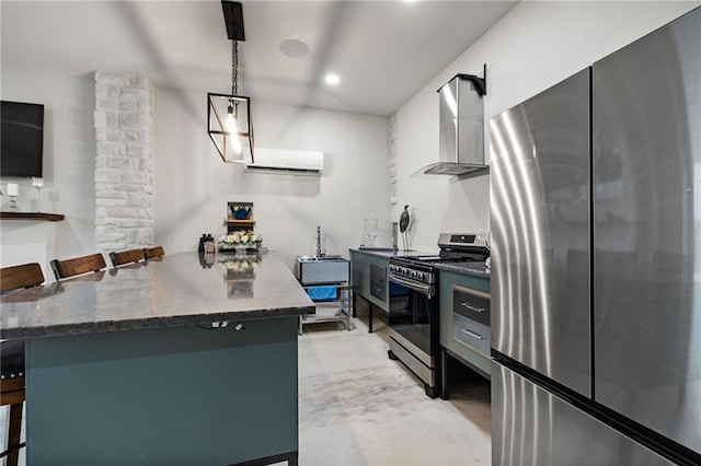 kitchen featuring wall chimney range hood, concrete flooring, a breakfast bar, an AC wall unit, and appliances with stainless steel finishes