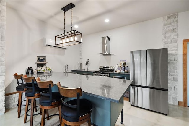 kitchen with a peninsula, a breakfast bar area, a wall mounted air conditioner, wall chimney range hood, and appliances with stainless steel finishes