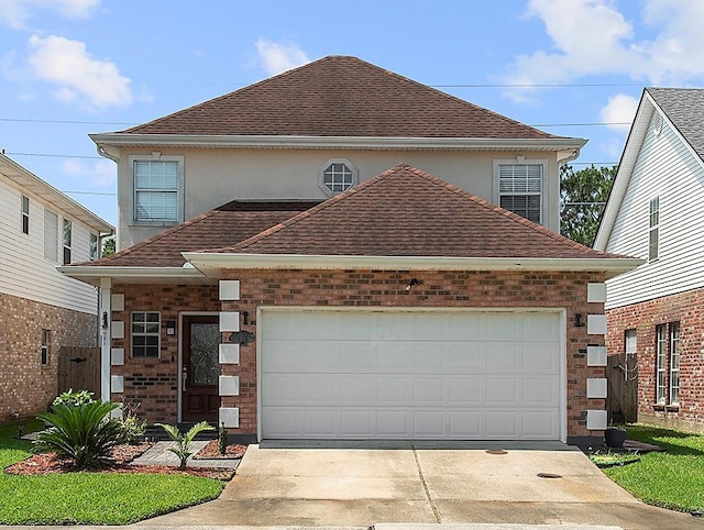 1001 W Chateau Lafitte Dr, Kenner, LA 70065 - view of front of home with driveway, a shingled roof, a garage, and stucco siding