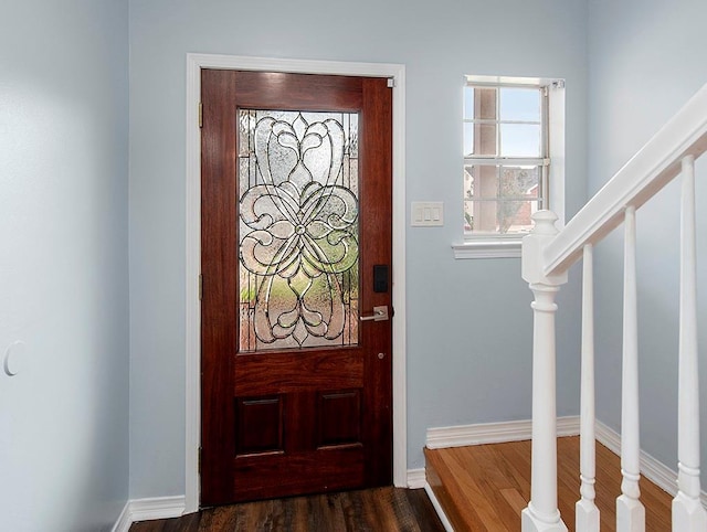 1001 W Chateau Lafitte Dr, Kenner, LA 70065 - entryway with stairs, dark wood finished floors, and baseboards