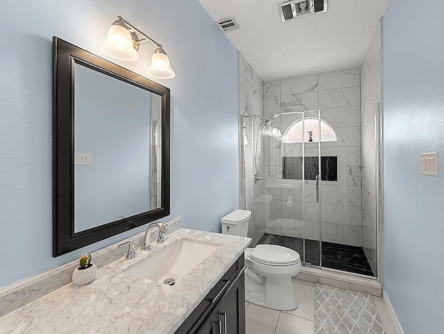 1001 W Chateau Lafitte Dr, Kenner, LA 70065 - bathroom featuring toilet, vanity, a stall shower, baseboards, and tile patterned flooring