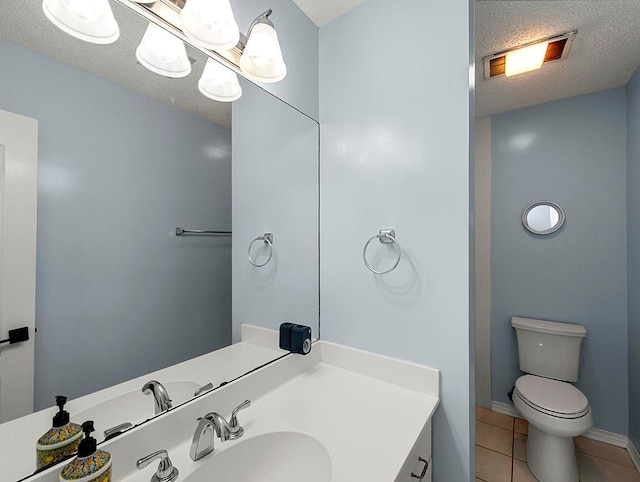 1001 W Chateau Lafitte Dr, Kenner, LA 70065 - bathroom with a textured ceiling, vanity, tile patterned floors, and toilet