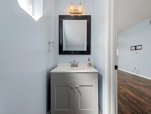1001 W Chateau Lafitte Dr, Kenner, LA 70065 - bathroom with vanity, wood finished floors, and baseboards