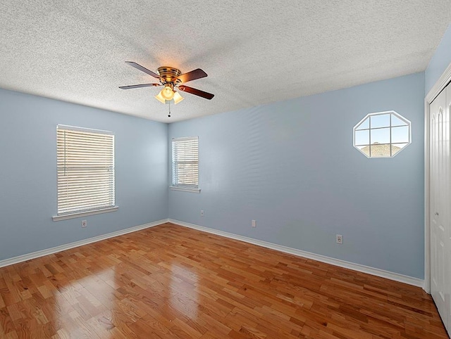 1001 W Chateau Lafitte Dr, Kenner, LA 70065 - unfurnished room featuring ceiling fan, wood finished floors, a textured ceiling, and baseboards