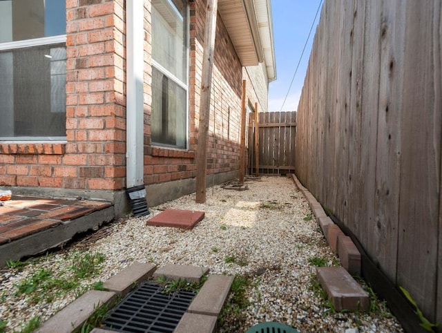 1001 W Chateau Lafitte Dr, Kenner, LA 70065 - view of side of home with brick siding and a fenced backyard